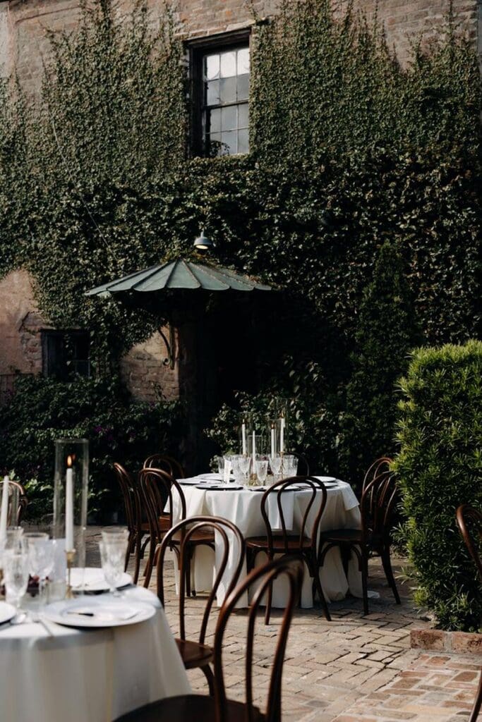 Wedding reception tables outdoor in courtyard at Race and Religion wedding venue